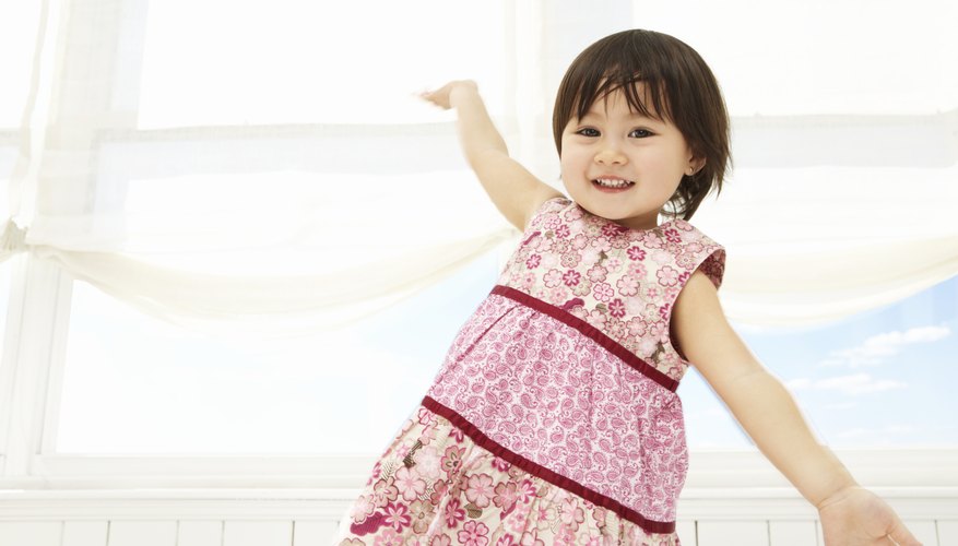 Natural-style pageants favor traditional toddler dresswear over glittery gowns. Natural-style pageants favor traditional toddler dresswear over glittery gowns.