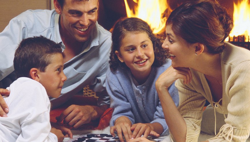 Family playing board game together. Family playing board game together.