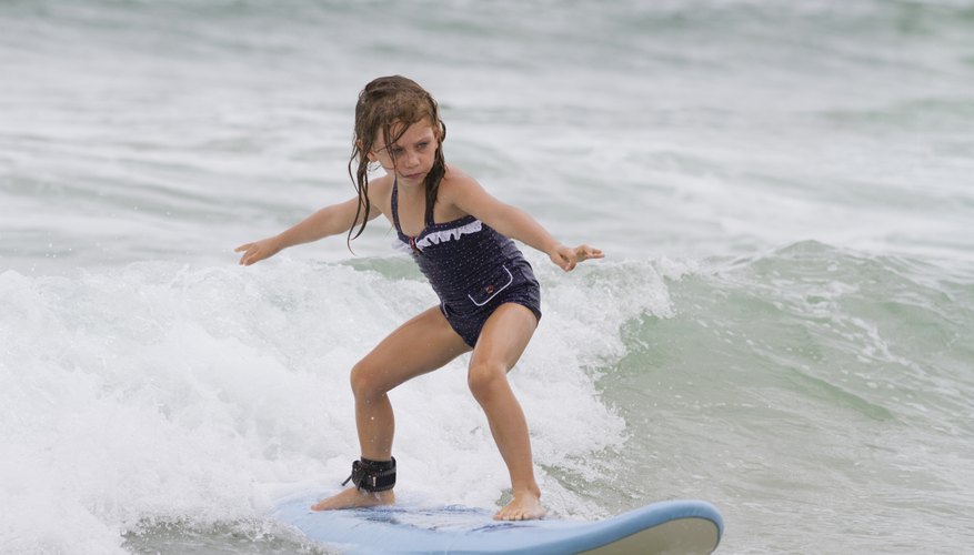 Young girl surfing a wave. Young girl surfing a wave.