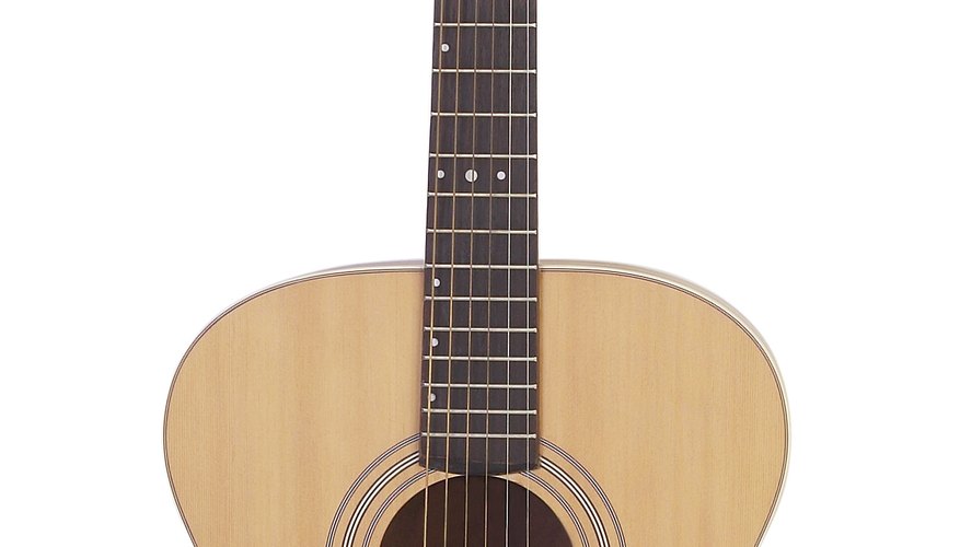 The nut separates the long guitar neck from the headstock at the top of the instrument. The nut separates the long guitar neck from the headstock at the top of the instrument.