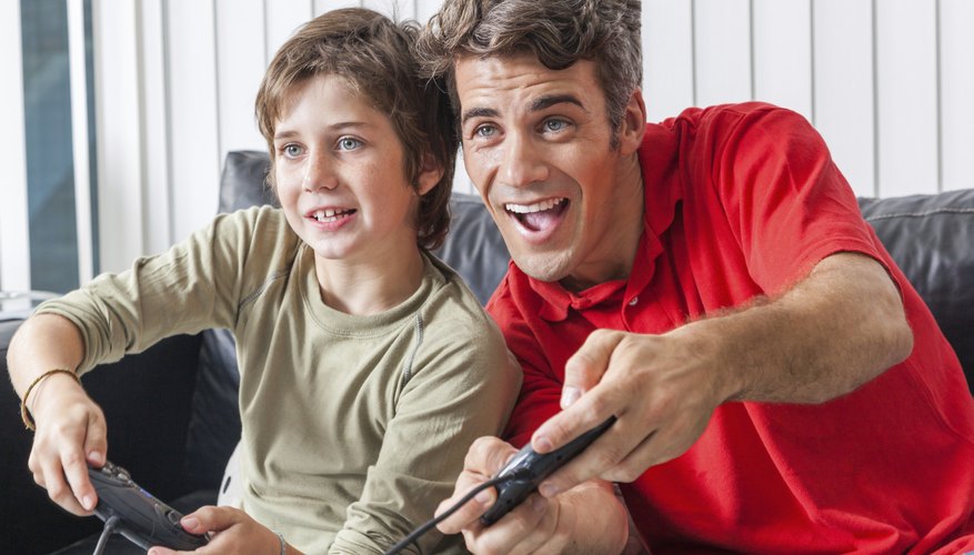 A father and son are playing video games. A father and son are playing video games.