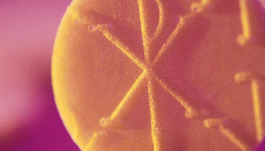 The Holy Eucharist is a thin wafer blessed by a priest. The Holy Eucharist is a thin wafer blessed by a priest.
