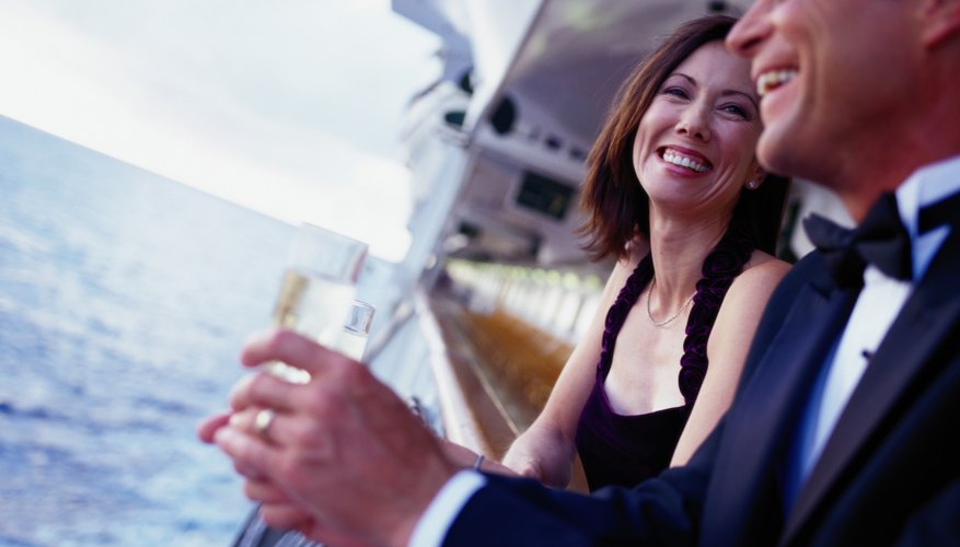 Photo Credit: Steve Mason/Photodisc/Getty Images Smiling couple on a cruise ship