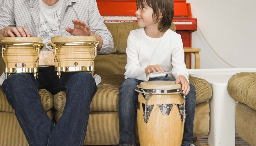 Father and son playing congas Father and son playing congas