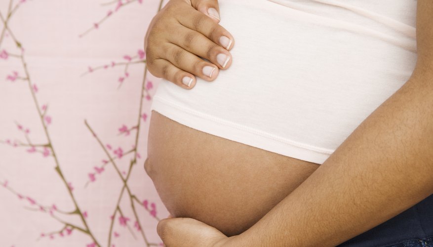 Pregnant woman holding her stomach. Pregnant woman holding her stomach.