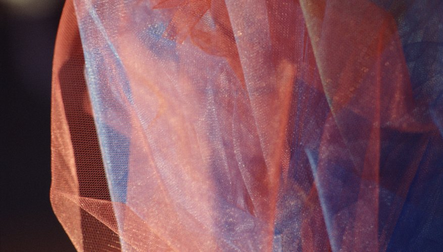 Sheer, delicate organza fabric can be curled to make a decorative edge. Sheer, delicate organza fabric can be curled to make a decorative edge.