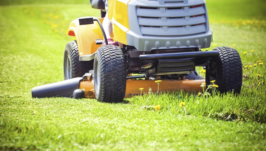 Close-up of a lawn tractor mowing grass Close-up of a lawn tractor mowing grass