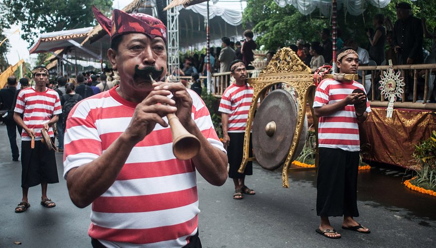 Flute player and gong on display during Bali festival Flute player and gong on display during Bali festival
