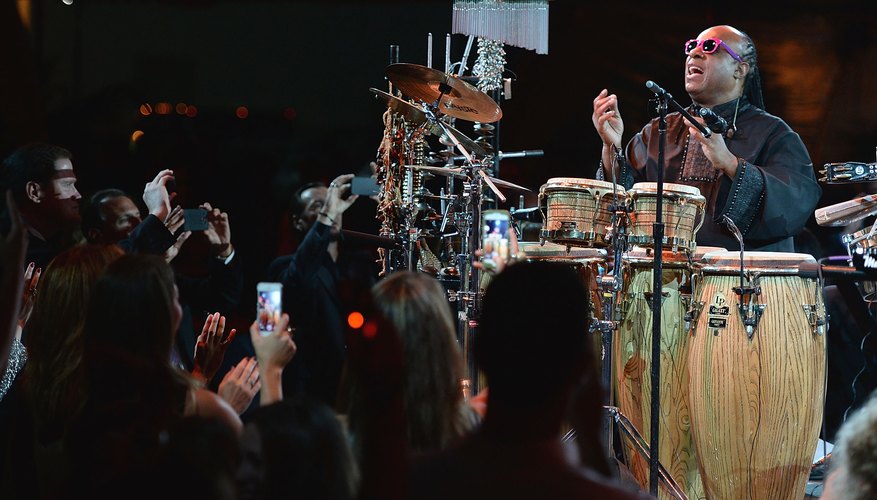 Photo Credit: Michael Kovac/Getty Images Entertainment/Getty Images Stevie Wonder playing a variety of instruments in concert.