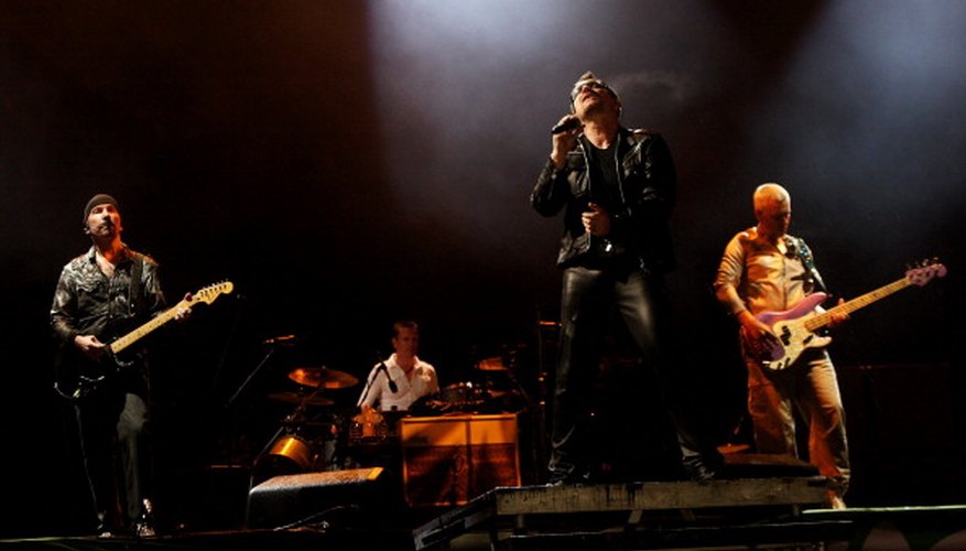 The Edge performs at Glastonbury Festival, his Vox amp on a riser behind Bono. The Edge performs at Glastonbury Festival, his Vox amp on a riser behind Bono.
