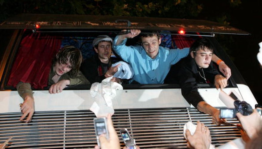 Photo Credit: Matt Cardy/Getty Images Entertainment/Getty Images Pete Doherty greets fans from the tour bus window.