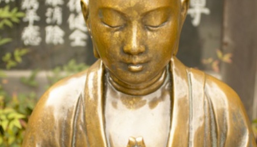 Photo Credit: Jupiterimages/Photos.com/Getty Images Brass statue of the Buddha.