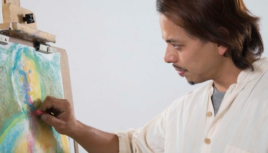 An artist sketches with a soft pastel. An artist sketches with a soft pastel.