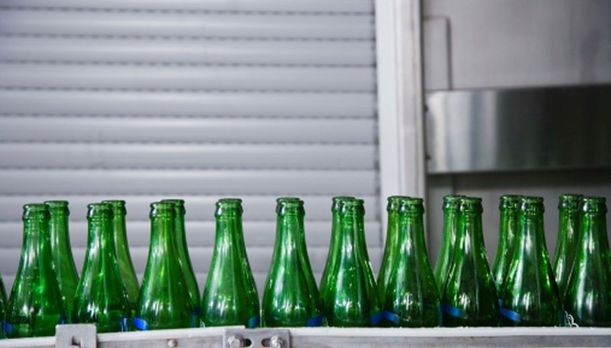 Glass bottles sparkle as garden borders. Glass bottles sparkle as garden borders.