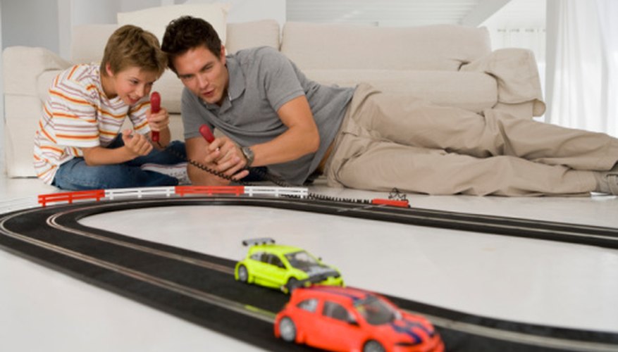 Slot cars run around tracks with slots that guide them. Slot cars run around tracks with slots that guide them.