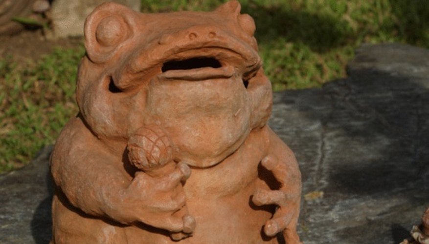 Photo Credit: NA/Photos.com/Getty Images In sapo, the goal is to send a coin into the frog's mouth.