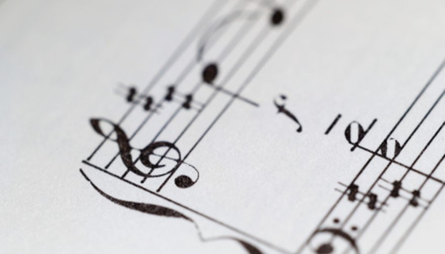 The bass clef looks like a backwards C with two dots that surround the F line. The bass clef looks like a backwards C with two dots that surround the F line.