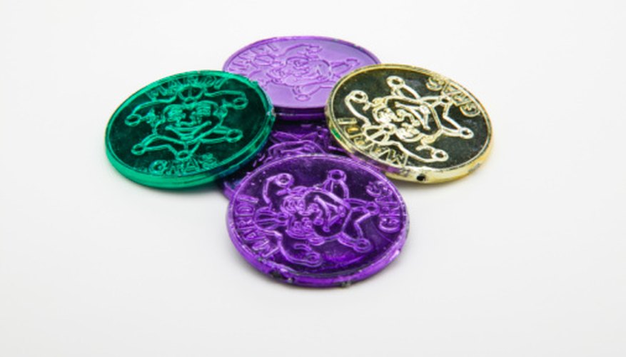 Photo Credit: Jupiterimages/liquidlibrary/Getty Images In addition to beads, Mardi Gras coins are popular