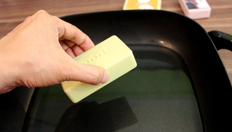 Dip the soap in the melted wax Dip the soap in the melted wax