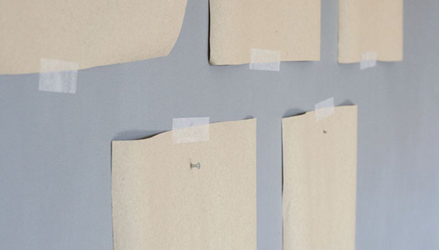 Add picture hanging nails right through the kraft paper. Add picture hanging nails right through the kraft paper.