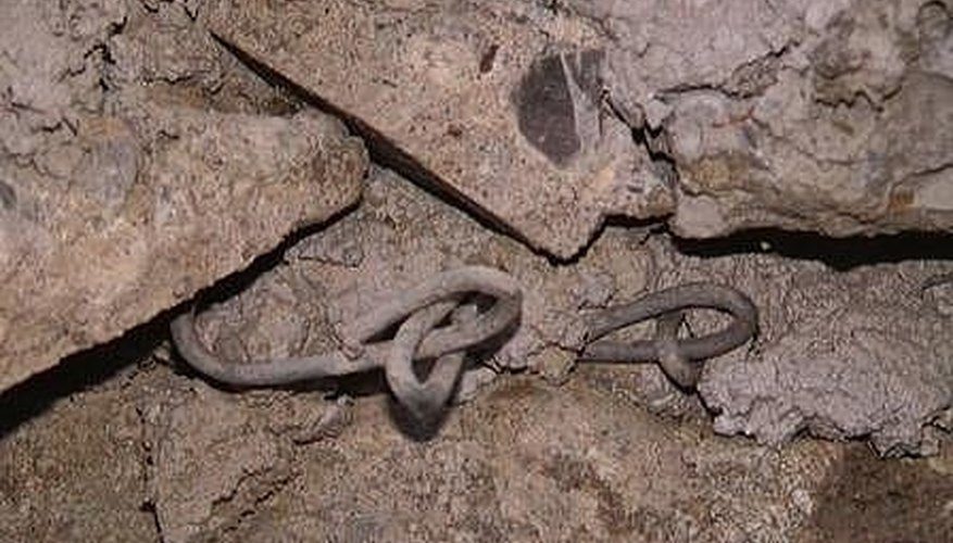Chainlink is set in between layers and anchored into the hillside to provide lateral strength. Chainlink is set in between layers and anchored into the hillside to provide lateral strength.