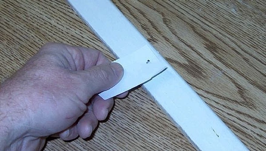 Here's a nail pushed through the piece of paper. Once the nail is driven in, simply pull out the paper. Here's a nail pushed through the piece of paper. Once the nail is driven in, simply pull out the paper.