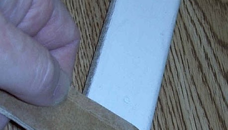 Slit in the cardboard strip holds the nail in position. Slit in the cardboard strip holds the nail in position.