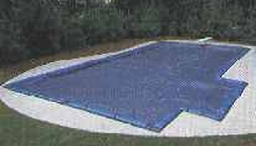 This inground swimming pool has been properly closed for the winter. This inground swimming pool has been properly closed for the winter.