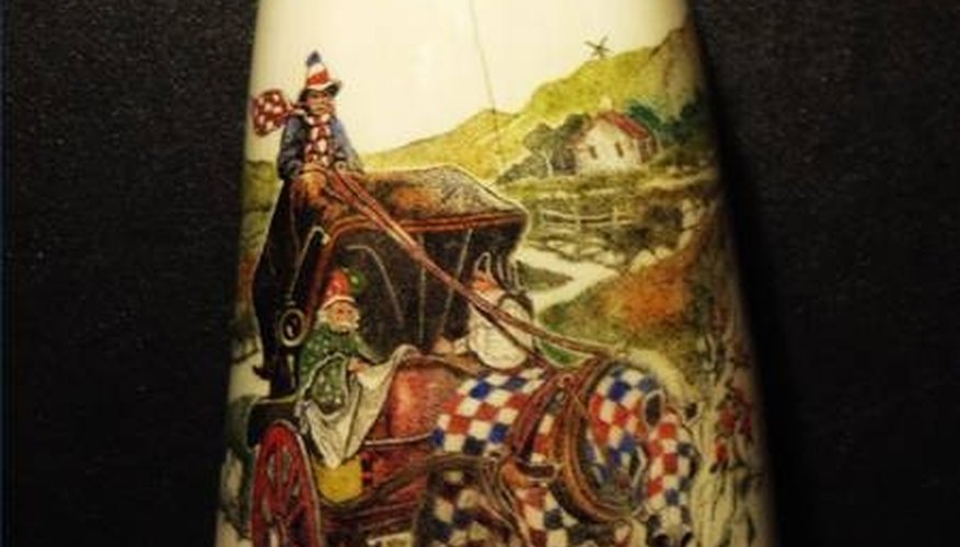 An intricately colored piece of scrimshaw on a whale tooth An intricately colored piece of scrimshaw on a whale tooth