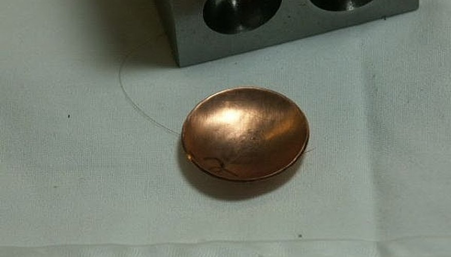 Domed copper disc. Domed copper disc.