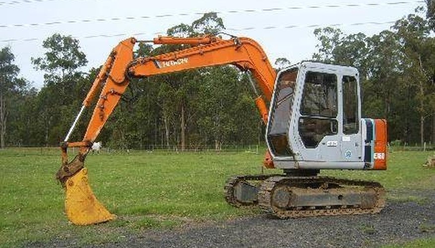 Use a small excavator like this one to begin tearing up the asphalt surface. Use a small excavator like this one to begin tearing up the asphalt surface.