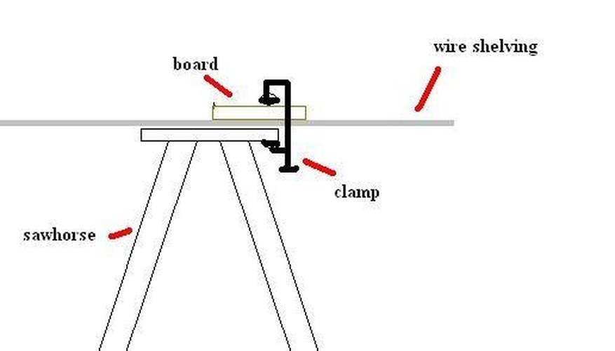 Clamping the wire shelving with a board and clamp Clamping the wire shelving with a board and clamp