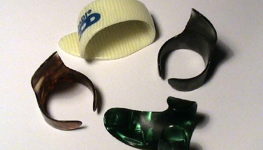 The white pick is the thumb pick, the black picks are the finger picks The white pick is the thumb pick, the black picks are the finger picks