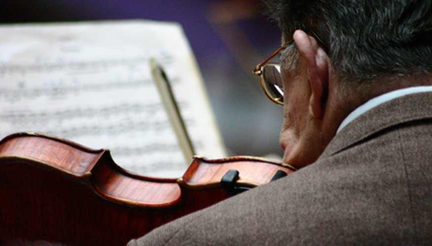 A violinist concentrates on his music. A violinist concentrates on his music.