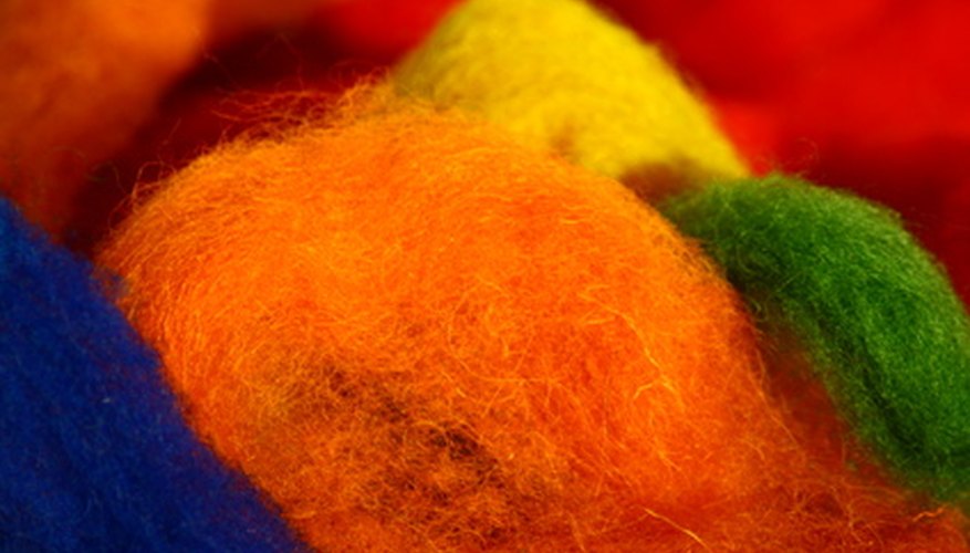 Raw wool is typically grey or black, but can be dyed before the felting process to create colorful patterns. Raw wool is typically grey or black, but can be dyed before the felting process to create colorful patterns.