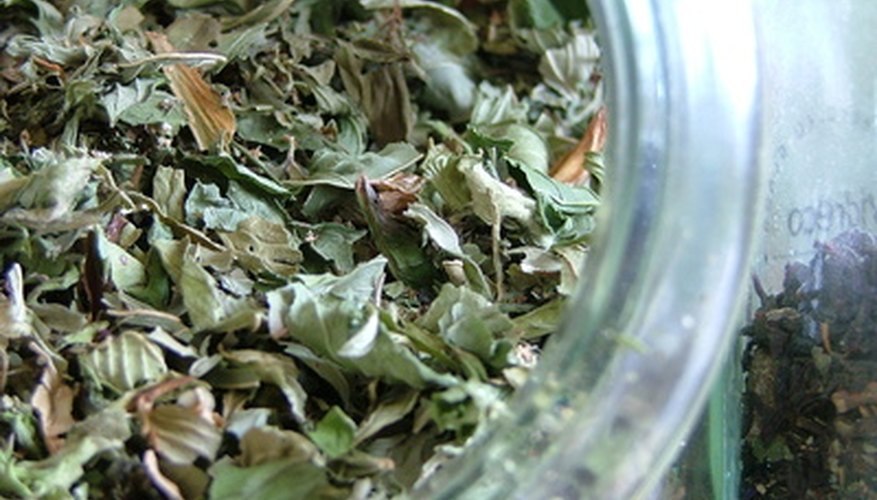 An open container of dried mint leaves releases mint fragrance. An open container of dried mint leaves releases mint fragrance.