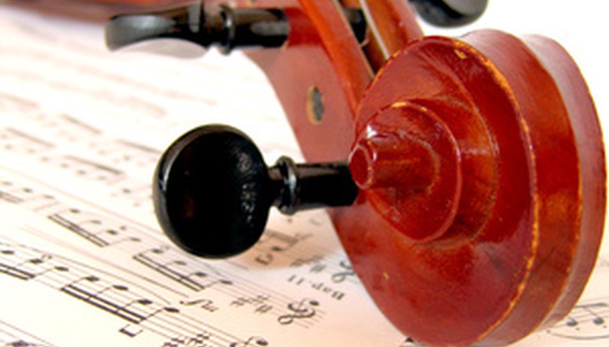 Violin pegs stick out from the scroll of the violin. Violin pegs stick out from the scroll of the violin.