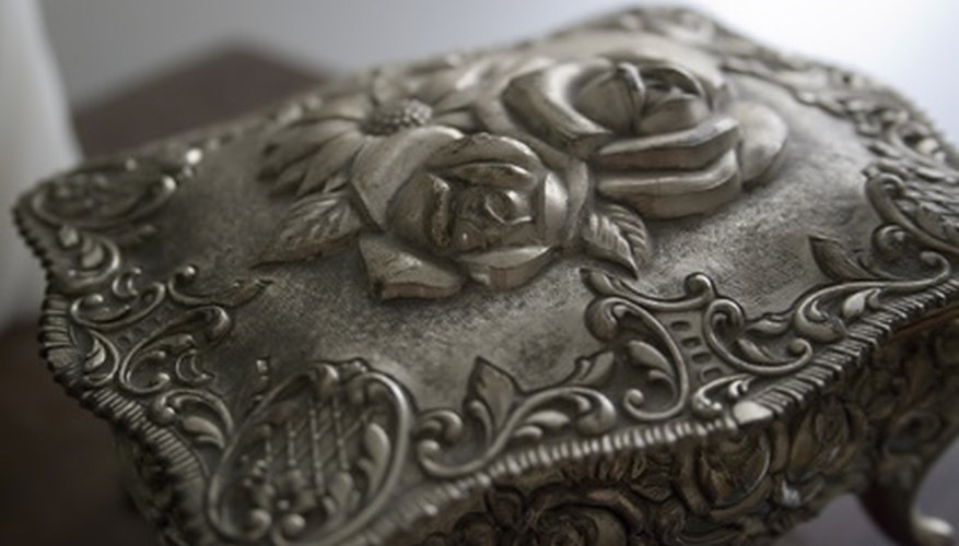 Pewter box has a rose design. Pewter box has a rose design.