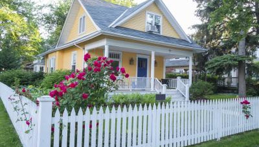 White picket fence with bungalow landscape White picket fence with bungalow landscape
