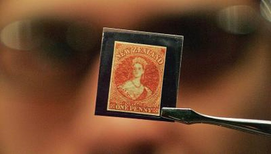 Stamp being inspected by appraiser Stamp being inspected by appraiser