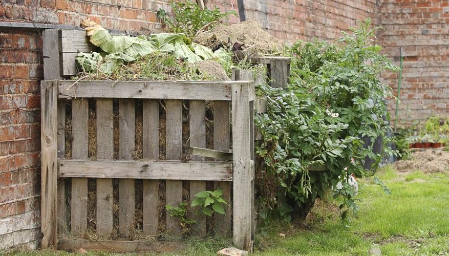 A compost heap in a wooden frame A compost heap in a wooden frame
