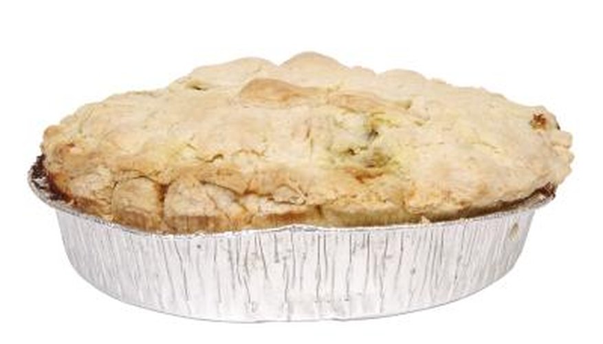 A used aluminum pie tin filled with cucumber slices deters garden pests. A used aluminum pie tin filled with cucumber slices deters garden pests.