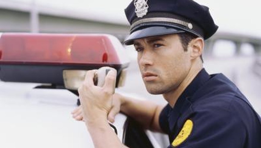 Police officer talking on a radio. Police officer talking on a radio.