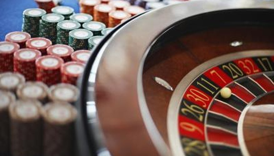Stack of chips next to roulette wheel Stack of chips next to roulette wheel