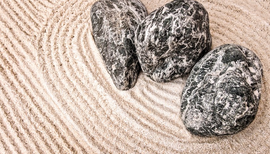 Zen gardens use sand and stones to create the illusion of water and land. Zen gardens use sand and stones to create the illusion of water and land.