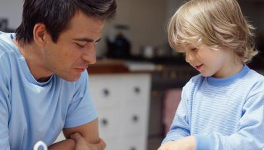 A father and son prepare a bowl of cereal together in the morning. A father and son prepare a bowl of cereal together in the morning.