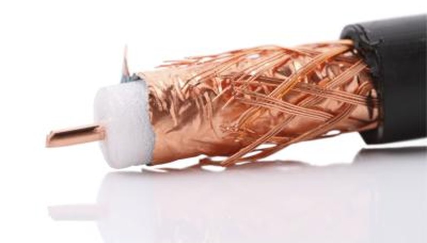 A close-up of coaxial cable shows the woven shield of copper that surrounds the insulating layer. A close-up of coaxial cable shows the woven shield of copper that surrounds the insulating layer.