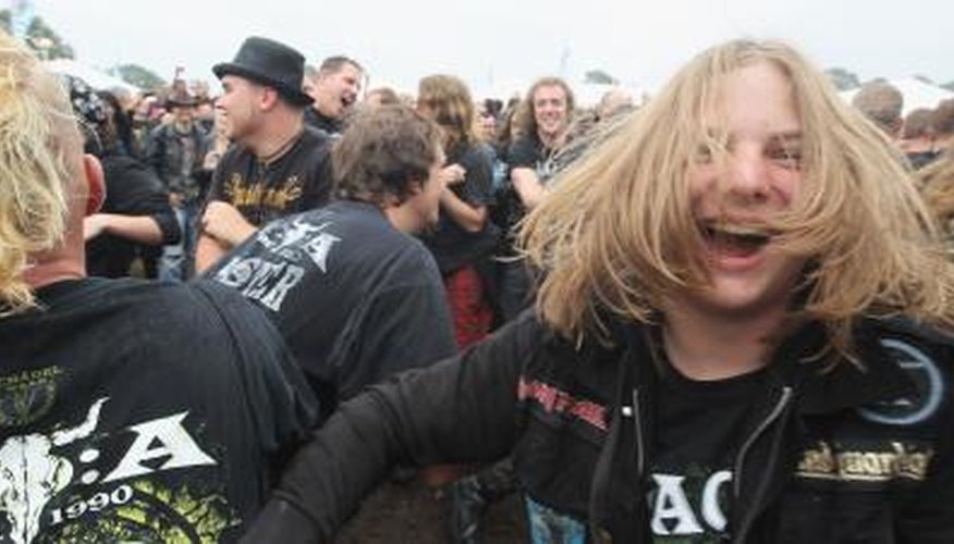 Heavy metal fans slam dance in mosh pit Heavy metal fans slam dance in mosh pit