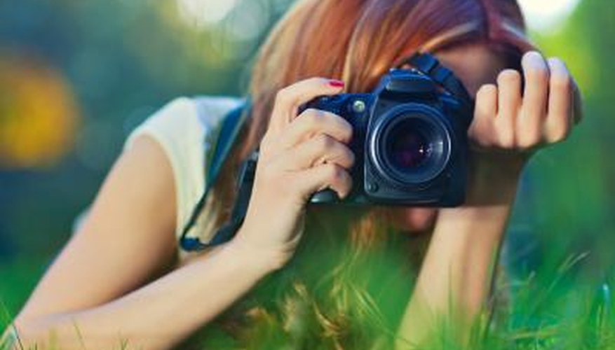 Young woman taking a picture with a camera outdoors. Young woman taking a picture with a camera outdoors.