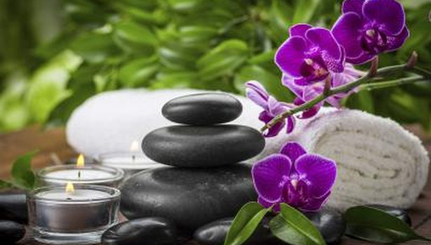 orchids beside candle and towel at beauty spa orchids beside candle and towel at beauty spa